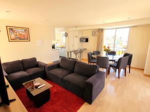 a living room with a couch and a table at Fiflos Apartament in Cusco