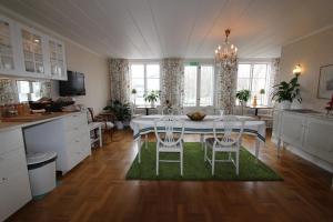 a kitchen and dining room with a table and chairs at Bed & Breakfast Villa Sedin in Härnösand