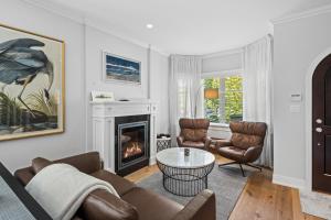 a living room with a couch and chairs and a fireplace at Superior Downtown Delight by Iris Properties! in Victoria