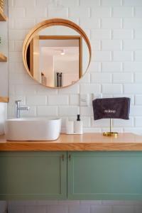 a bathroom with a sink and a mirror at Bright & sweet unit in the heart of Polanco. in Mexico City