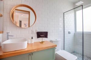 a bathroom with a sink and a mirror at Bright & sweet unit in the heart of Polanco. in Mexico City +103 photos