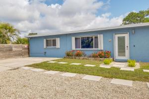 a blue house with a garden in front of it at Private Pool and Patio Fort Lauderdale Home! in Fort Lauderdale