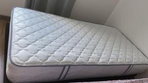 a white mattress sitting on top of a bed at HABITACION DOBLE con baño compartido en apartamento compartido in Bucaramanga