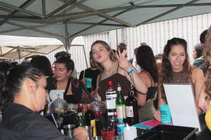 a group of women standing around a table with bottles of wine at Vila Rock Hostel - próximo Allianz Parque, Vila Madalena, Av Paulista, Hospital das Clínicas INCOR FMUSP in São Paulo