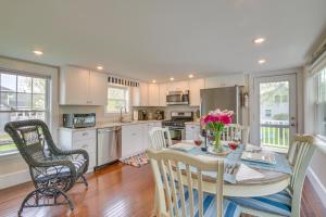 a kitchen with a table with flowers on it at Rockland Home with Deck 5 Mins to Historic Downtown! in Rockland