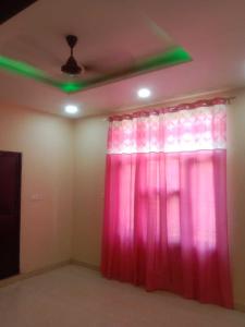 a room with a pink curtain and a ceiling at OYO 81141 Mangal Bhawan in Kānpur