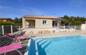 a swimming pool in front of a house at 2 Bedroom Amazing Home In Saint-ambroix in Saint-Ambroix