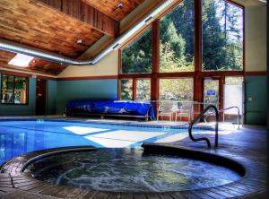 a swimming pool in a house with a large window at Mt Baker Den, Sleeps 4 in Glacier