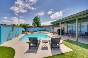 a patio with chairs and a swimming pool at Vibrant, Colorful Tucson Abode w/ Pool & Hot Tub in Tucson