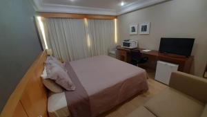 Ένα ή περισσότερα κρεβάτια σε δωμάτιο στο Mediterrâneo Flat - Apart-Hotel +34 φωτογραφίες