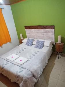 a bedroom with a large white bed with two pillows at El refugio Anillaco in Anillaco