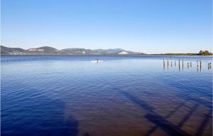a person on a paddle board in a large body of water at Casa Le Vallette in Massarosa