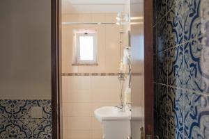 La salle de bains est pourvue de toilettes, d'un lavabo et d'une fenêtre. dans l'établissement Casa Sabino, à Almádena