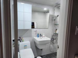 a white bathroom with a sink and a toilet at 10 mins from Nowon Station! Happy House in Seoul