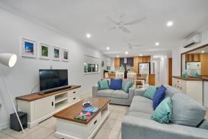 a living room with two couches and a tv at Arlington Apartments in Clifton Beach