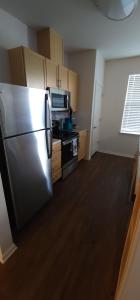 a kitchen with a stainless steel refrigerator and a stove at Beale Streeters Delight in Memphis