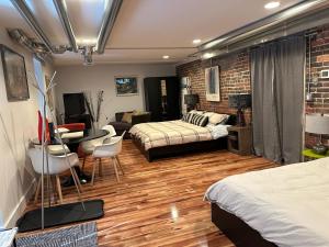 a bedroom with two beds and a table and chairs at Historical Oscar Lofquist house in the heart of Des Moines in Des Moines