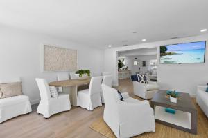 a living room with white furniture and a table and chairs at Santa Lucia Estate - Hotel Homes in West Palm Beach