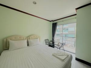 Postel nebo postele na pokoji v ubytování Cocoon Omaya Guest House