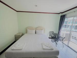 Postel nebo postele na pokoji v ubytování Cocoon Omaya Guest House