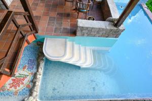 an overhead view of a swimming pool with a bench in it at TheTerrace -$1Mil Piton View in Soufrière