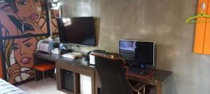 a room with a desk with a computer and a monitor at Design T Motel in Ulsan