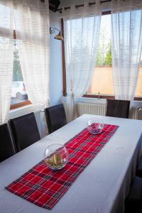 a table with two glass bowls on top of it at Pensiunea Riffelt in Bran