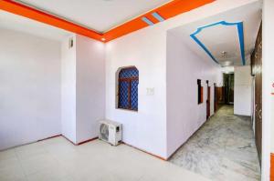 a room with white walls and an orange ceiling at OYO 81146 Hotel Prashant Villa in Gwalior