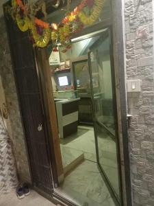 a mirror in a room with a sink and a desk at OYO 81095 Hotel Nathdwara in Nāthdwāra