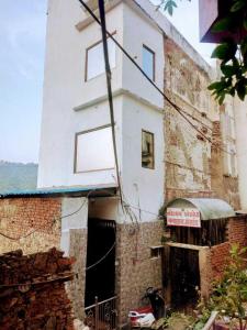 a white building with a sign on the side of it at OYO 81095 Hotel Nathdwara in Nāthdwāra
