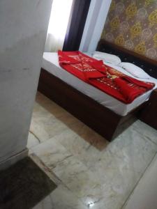a bed with red pillows on top of it at OYO 81095 Hotel Nathdwara in Nāthdwāra
