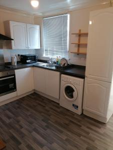 a kitchen with a washing machine and a dishwasher at Home of maximum relaxation/rest in Gillingham