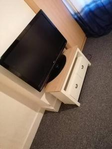 a flat screen tv sitting on top of a cabinet at Home of maximum relaxation/rest in Gillingham