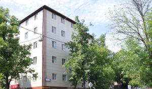 a white building with trees in front of it at Sokolniki Hotel in Moscow