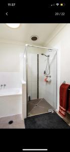 a shower with a glass enclosure in a bathroom at Private Room with Separate Bath in Shared Accommodation in Redcliffe