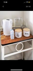 a shelf with three bowls and other kitchen items on it at Private Room in Shared Accommodation in Redcliffe