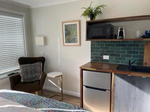 a bedroom with a bed and a desk and a chair at Studio 16 in Kyneton