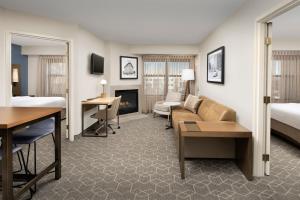 a hotel room with a bed and a living room at Residence Inn Denver South/Park Meadows Mall in Centennial