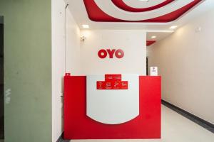 a coo sign on a wall next to a coke machine at OYO Flagship ELEGANT RESIDENCY in Chennai