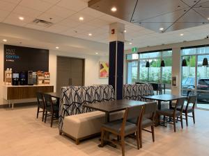 a waiting area with tables and chairs in a store at Holiday Inn Express & Suites - Courtenay - Comox, an IHG Hotel in Courtenay