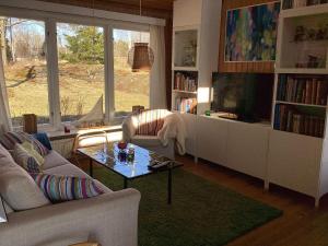 a living room with a couch and a tv and a table at Holiday home Vingåker III in Vingåker