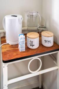 a shelf with three bowls and a blender on it at Private Room with Separate Bath in Shared Accommodation in Redcliffe