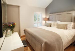 a bedroom with a large bed and a window at Nos Da in Pencoed