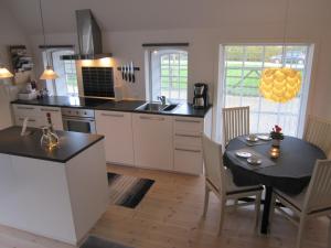 a kitchen with a table and a dining room at Tåsinge B&B in Svendborg