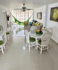 sala de estar con mesa, sillas y sofá en Apartamento en el Rodadero, Confortable y amplio, con vista al mar, a 80mt de la playa, DELAMAR Apartmet, en Santa Marta