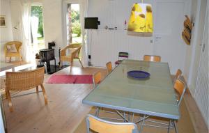 a dining room with a blue table and chairs at Holiday Home Strandkrogen Ix in Dronningmølle