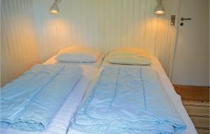 two twin beds in a room with two pillows at Holiday Home Strandkrogen Ix in Dronningmølle +5 photos