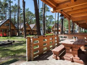 a wooden porch with a wooden bench on a deck at Spacious and comfortable holiday houses close to the beach, Pobierowo in Pobierowo