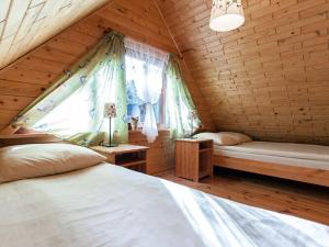 a bedroom with two beds and a window at Spacious and comfortable holiday houses close to the beach, Pobierowo in Pobierowo