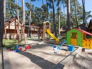 a playground with play equipment in the sand at Spacious and comfortable holiday houses close to the beach, Pobierowo in Pobierowo